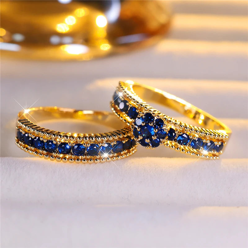 Set of blue cubic zirconia engagement rings from Corporación Turística with sparkling stones and intricate band designs.