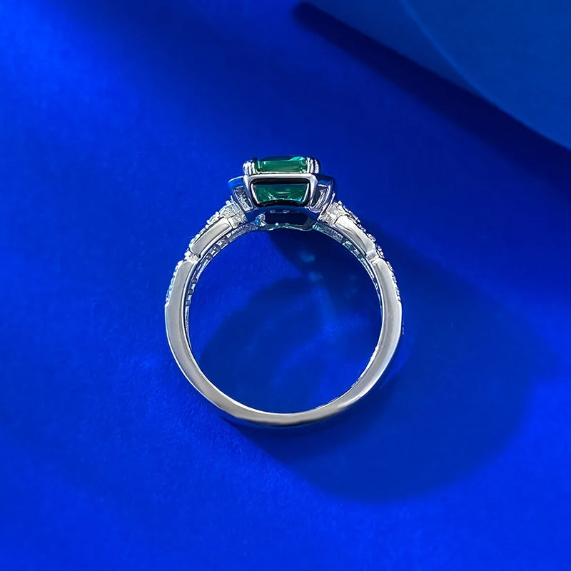 Luxury 18K solid white platinum ring with green accents, featuring a sleek, polished design and intricate craftsmanship.