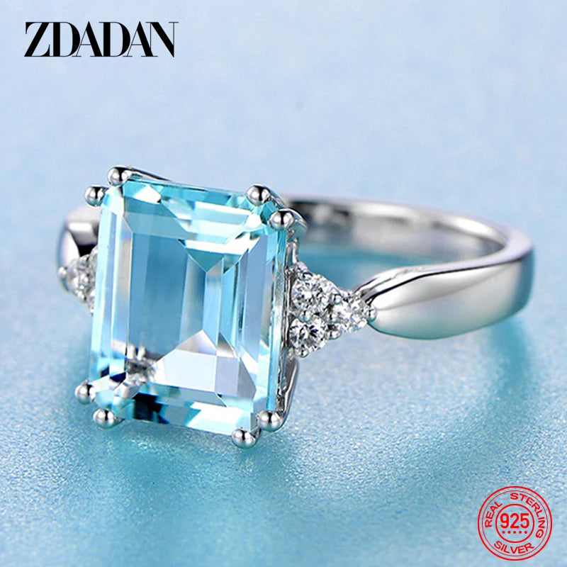 Silver ZDADAN aquamarine gemstone ring for women featuring a sparkling blue stone and intricate band design.