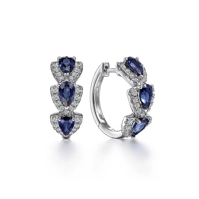 Blue cubic zirconia hoop earrings for women, stylish jewelry with sparkling gemstones, shown on a white background.