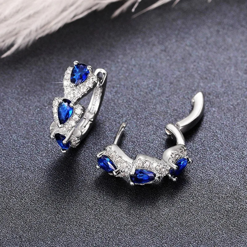 Blue cubic zirconia hoop earrings for women, featuring shiny circular design with sparkling stones.