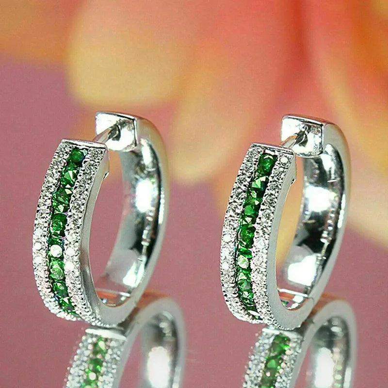 Sterling silver hoop earrings with cubic zirconia from Corporación Turística, showcasing shiny, elegant jewelry design.