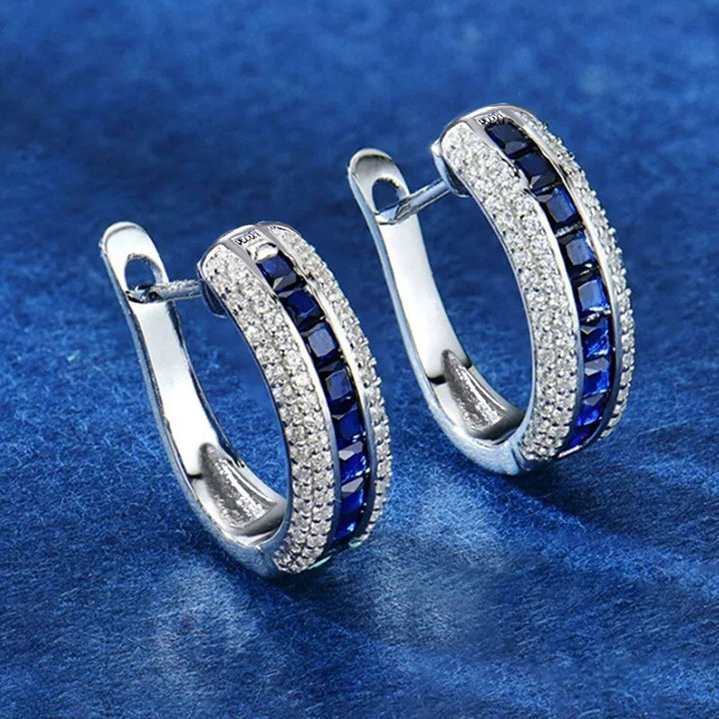 Silver 925 sterling hoop earrings with cubic zirconia from Corporación Turística, showcasing shiny, elegant jewelry.