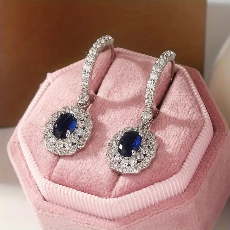 Sterling silver 925 dangling earrings with gemstone inlay, showcasing elegant jewelry design and craftsmanship.