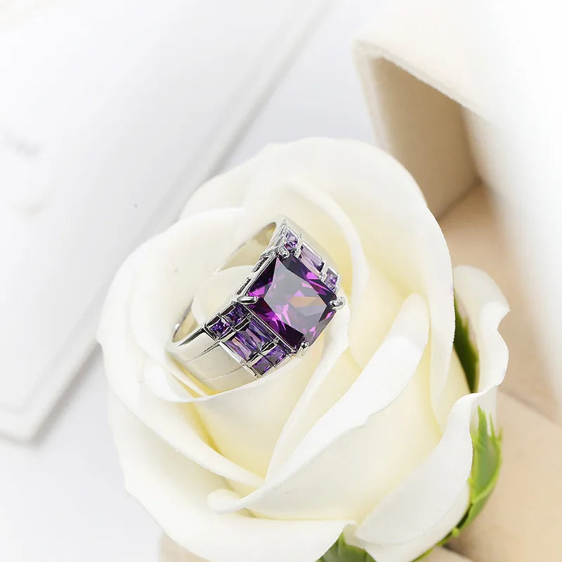 Wide purple cubic zirconia ring for women, fashion jewelry by Corporación Turística, showing the sparkling band on a hand.