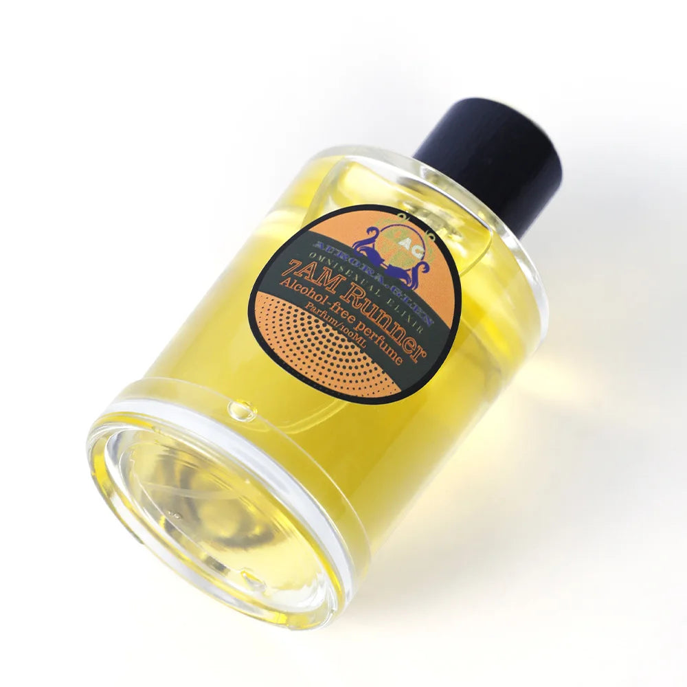 Essential oil spray with woody spicy fragrance by Corporación Turística, shown in a sleek bottle with a spray nozzle.