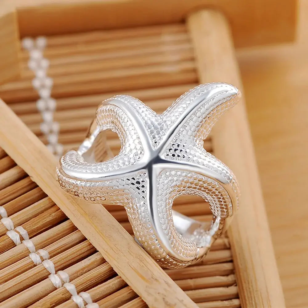 Large sterling silver starfish rings by Corporación Turística, detailed design, elegant jewelry for beach or casual wear.