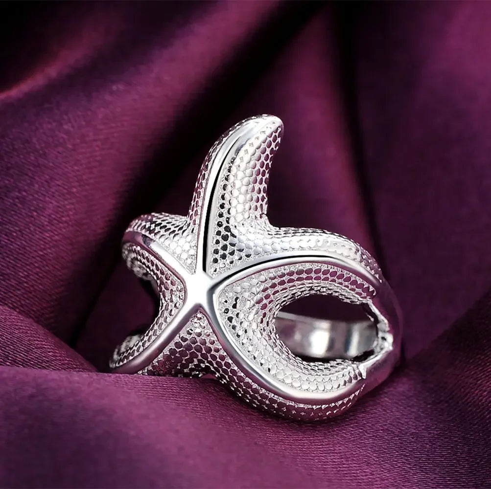 Large silver starfish rings from Corporación Turística, fine sterling silver jewelry featuring detailed starfish designs.