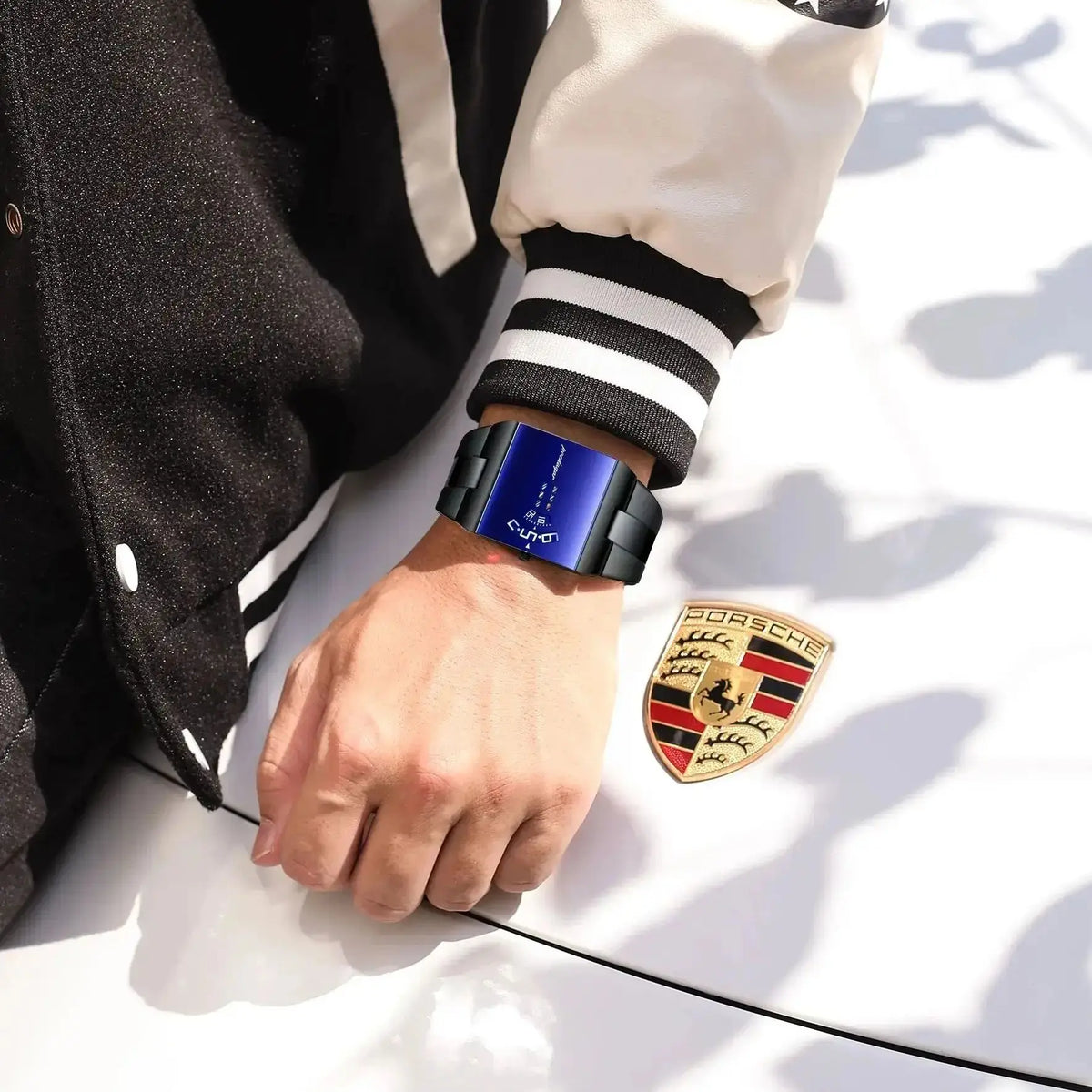 Black and gold rectangular men's sports watch by POEDAGAR, original design from Corporación Turística, with a sleek modern look.