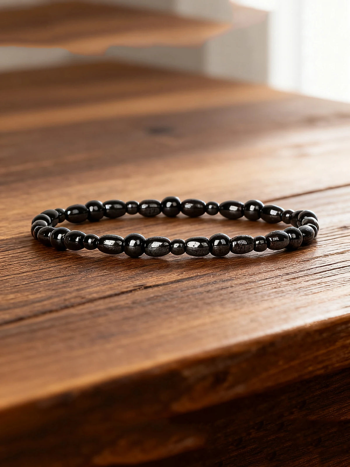 Hematite bracelet with rectangular natural stone beads, 19cm length, featuring sleek black metallic finish.