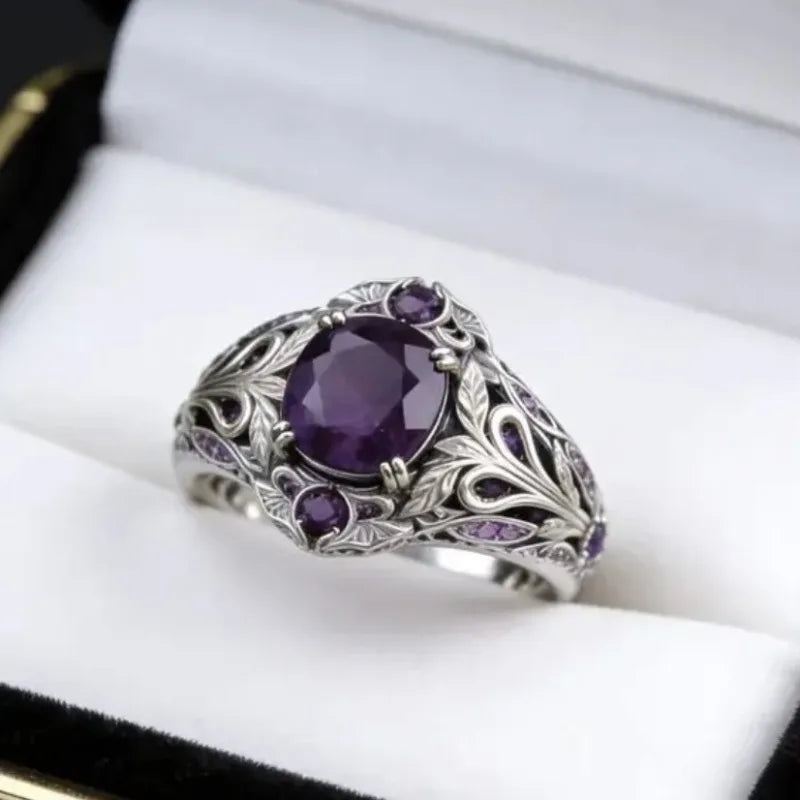 Retro fashion ring with purple cubic zirconia embellishments, featuring a bold design and intricate metalwork.