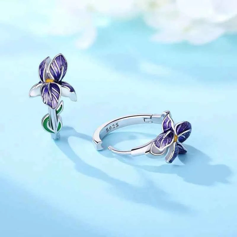 Sterling silver earrings with floral and iris design, crafted by Corporación Turística, showcasing intricate metalwork and elegant style.