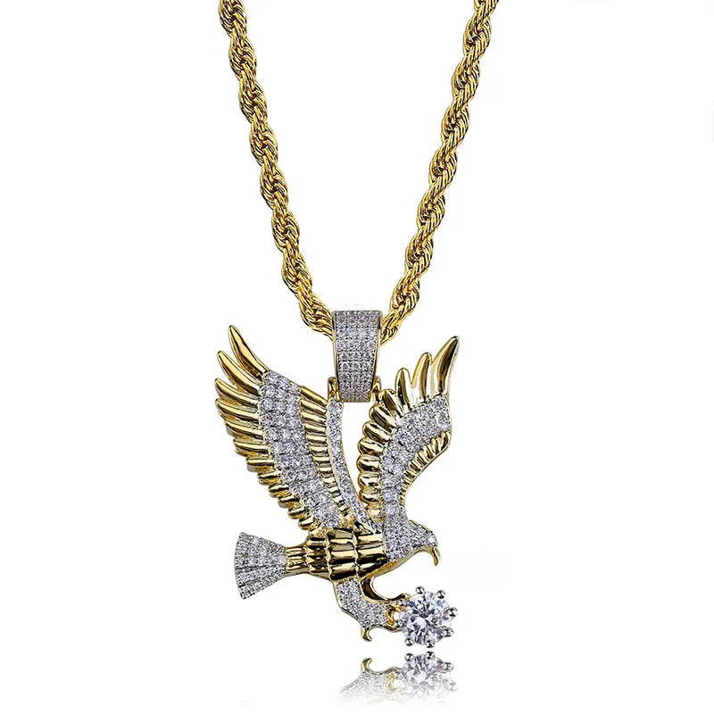 Gold eagle-shaped animal pendant necklace from Corporación Turística, featuring a detailed flying eagle design on a collar.