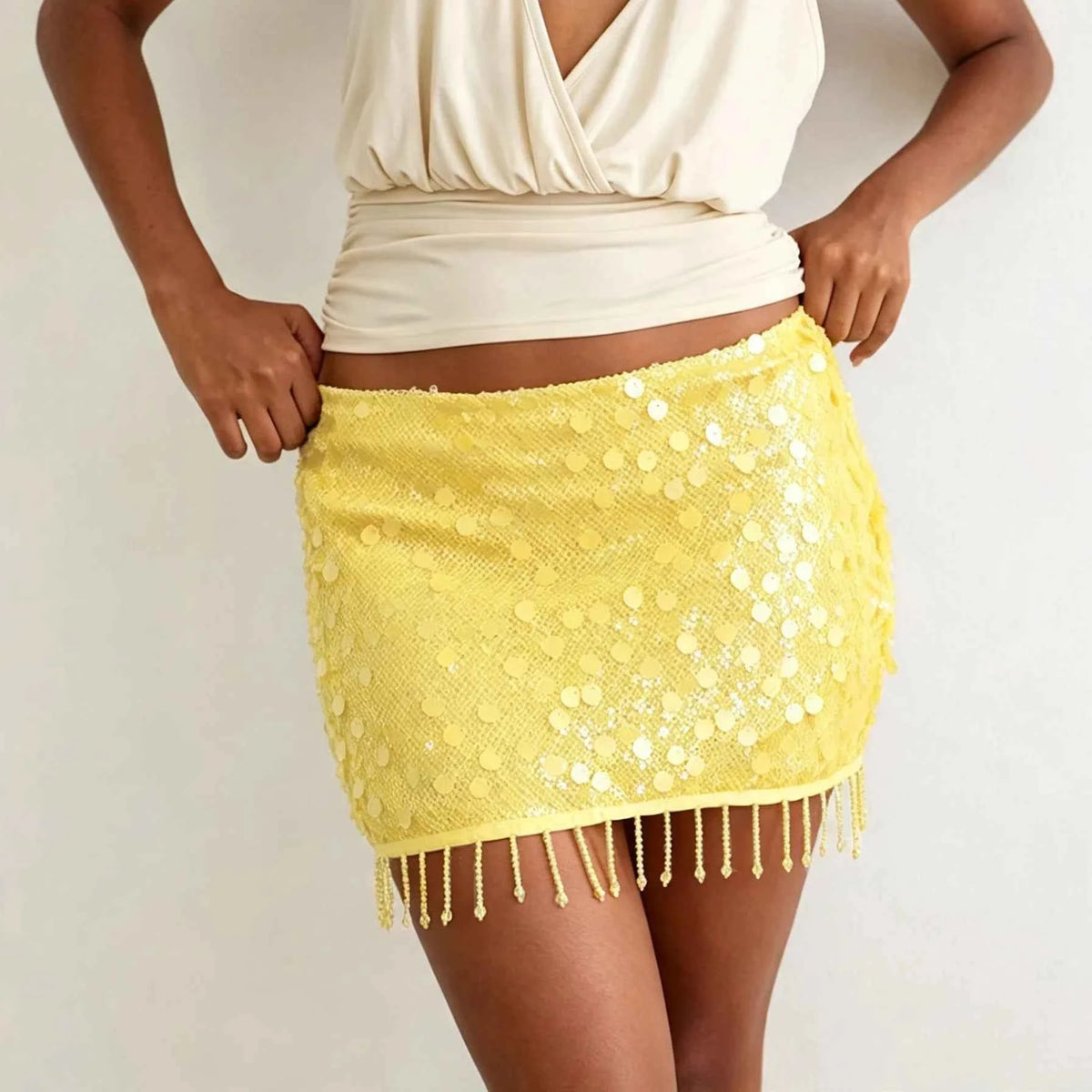 Bright yellow women's sequin mini skirt from Corporación Turística, featuring a shiny, micro-fit design with sparkling sequin details.