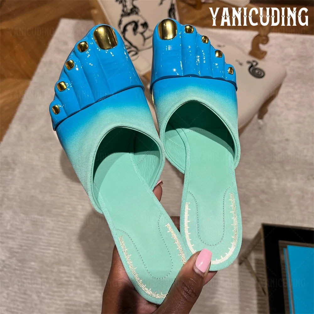 Turquoise gradient effect leather mules by Corporación Turística, painted in soft pastel blue with a sleek design.