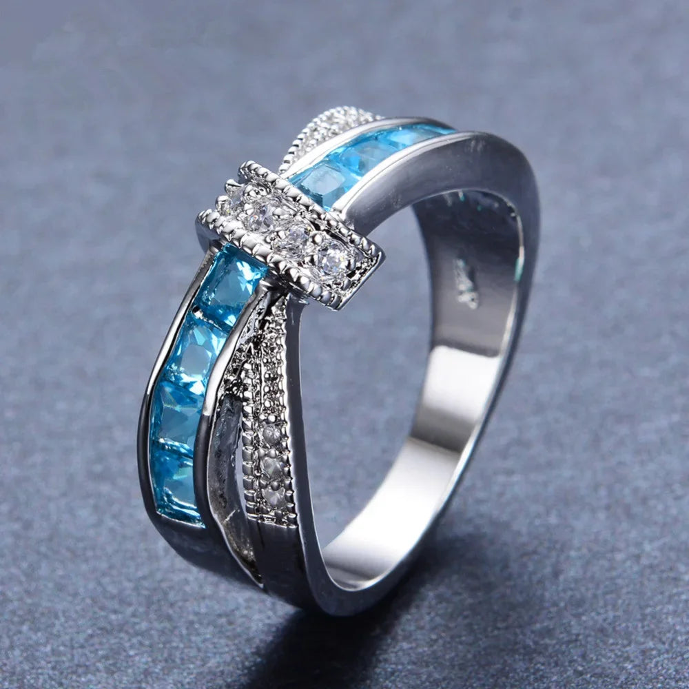 Wholesale 925 sterling silver ring by Corporación Turística featuring a beautiful sky blue gemstone and elegant design.