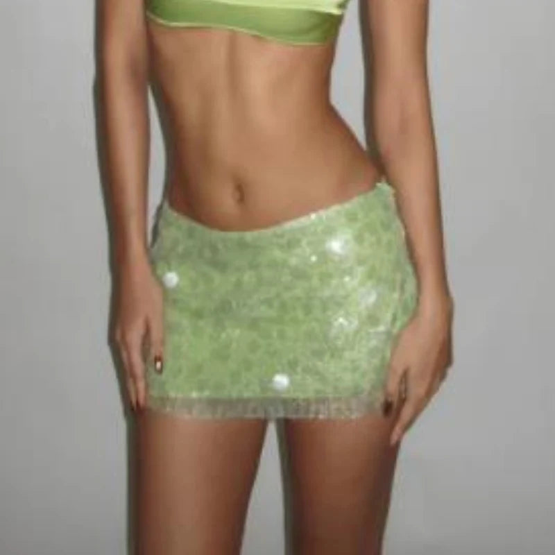 Blue glitter mini skirt for women, shiny and sexy, by Corporación Turística, showcased on a model.