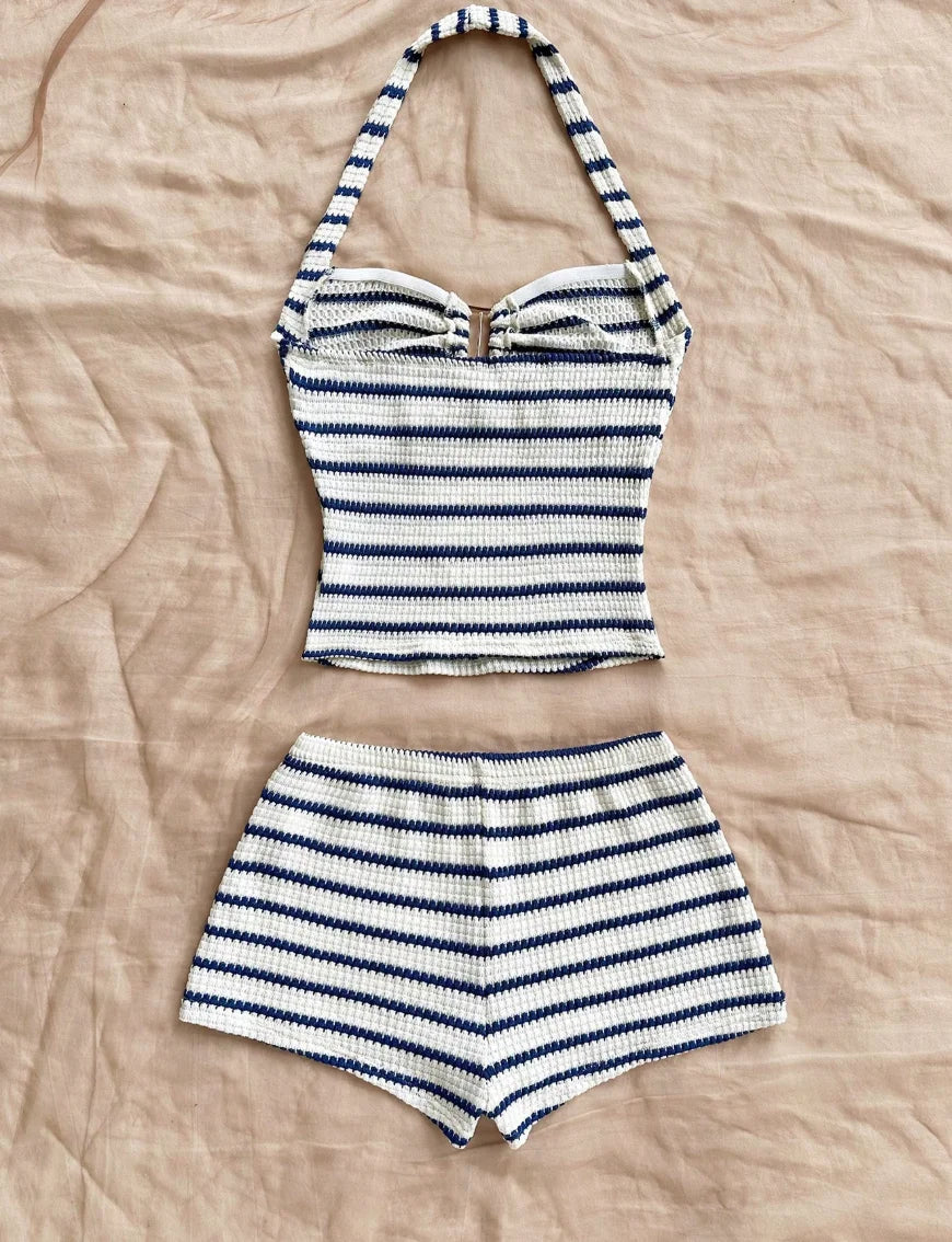 Blue summer two-piece set with halter top and knit fabric, designed by Corporación Turística, shown in image.