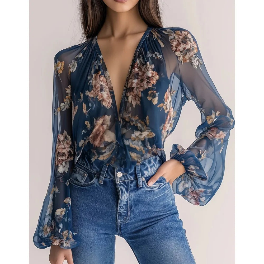 Blue sexy chiffon blouse with deep V-neck and floral print, by Corporación Turística, shown on a model.