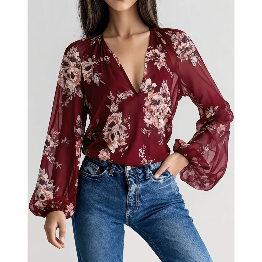 Blue silky blouse by Corporación Turística with deep V-neck and floral print, featuring lightweight, flowy fabric and stylish design.
