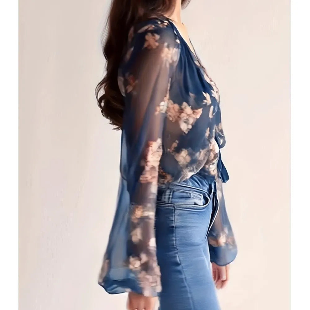 Blue sexy chiffon blouse with deep V-neck and printed design, made by Corporación Turística, shown on a model.