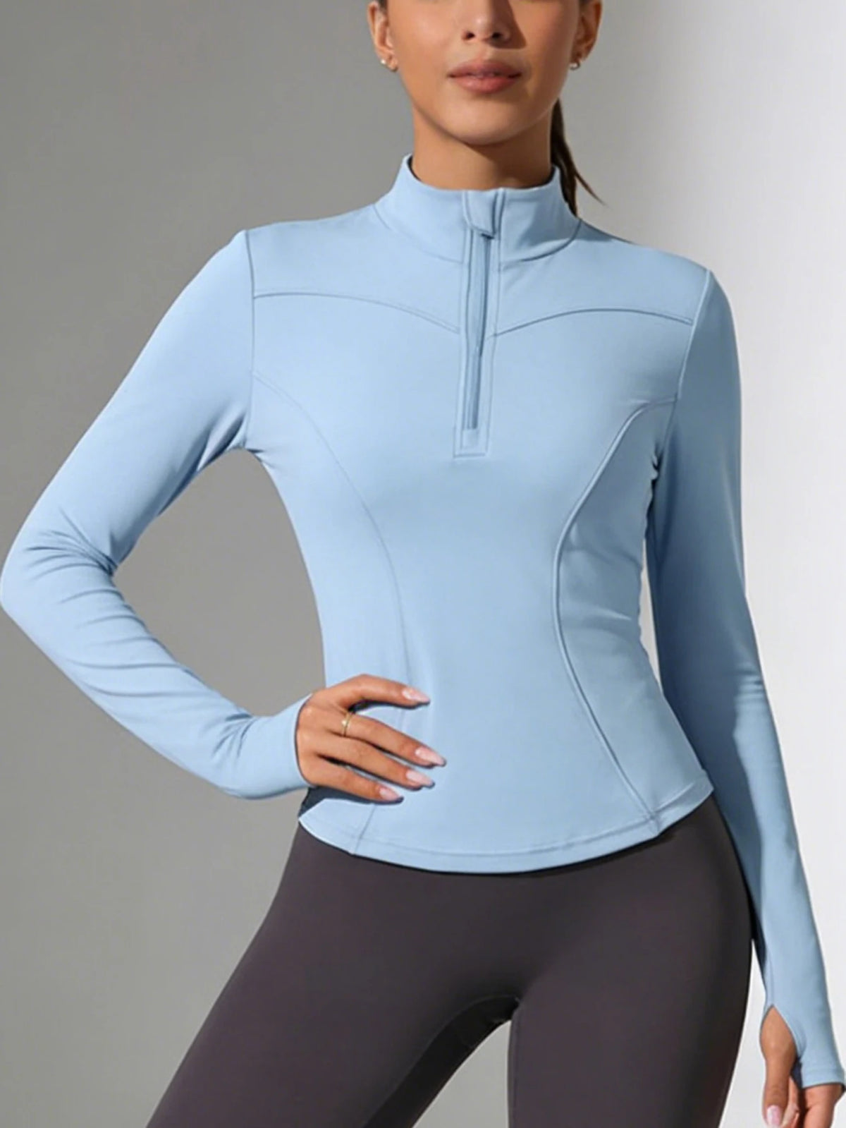 Blue women's fitted yoga sports t-shirt with long sleeves from Corporación Turística, ideal for active wear and yoga practice.