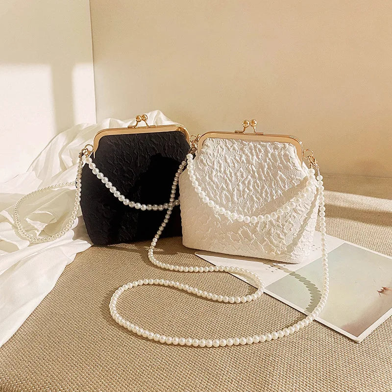 Beige crossbody phone purse with chain from Corporación Turística, featuring a compact design and stylish look.