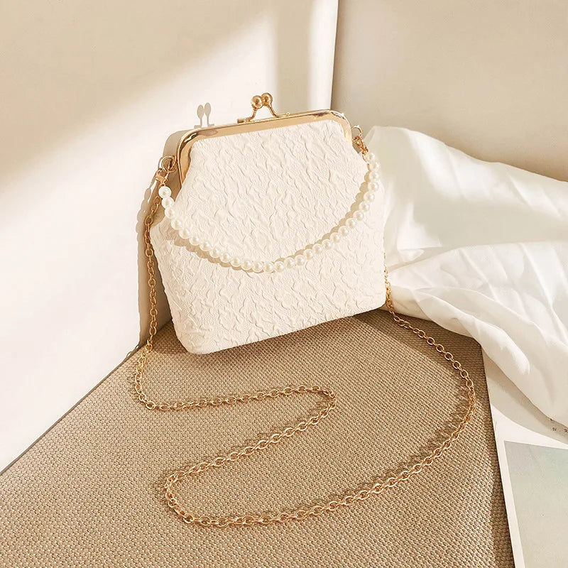 Beige crossbody phone bag with chain strap from Corporación Turística, designed for mobile phones and stylish everyday use.