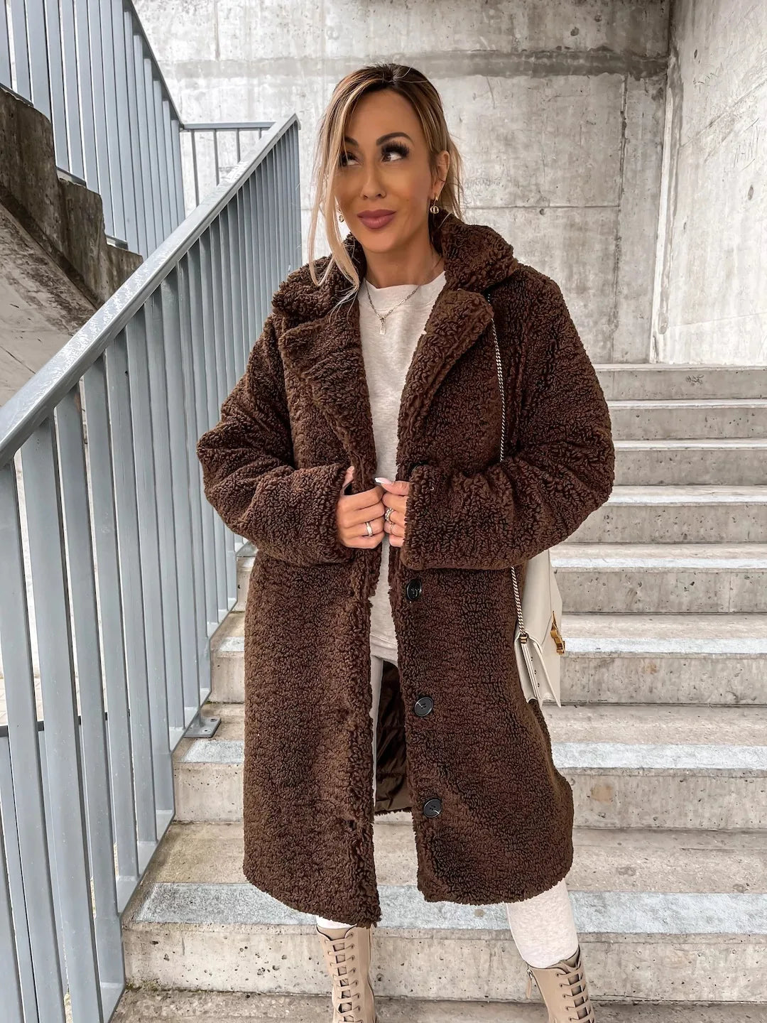 Beige long, loose, casual winter coat from Corporación Turística, made of soft, thick, warm, and plush fabric.