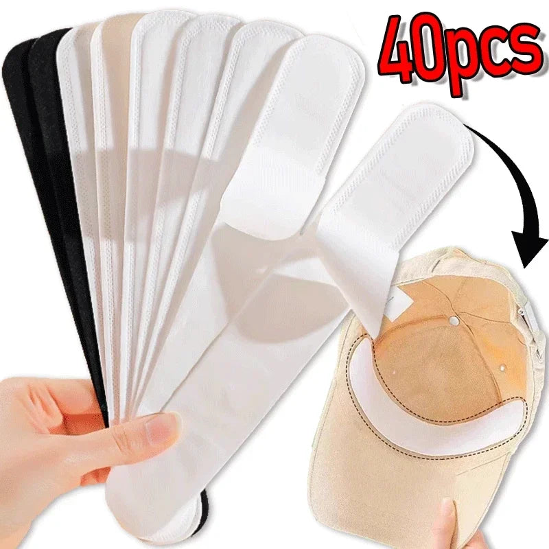 Set of 10/40 absorbent sweat stickers for hats by Corporación Turística, shown adhered inside a black hat.
