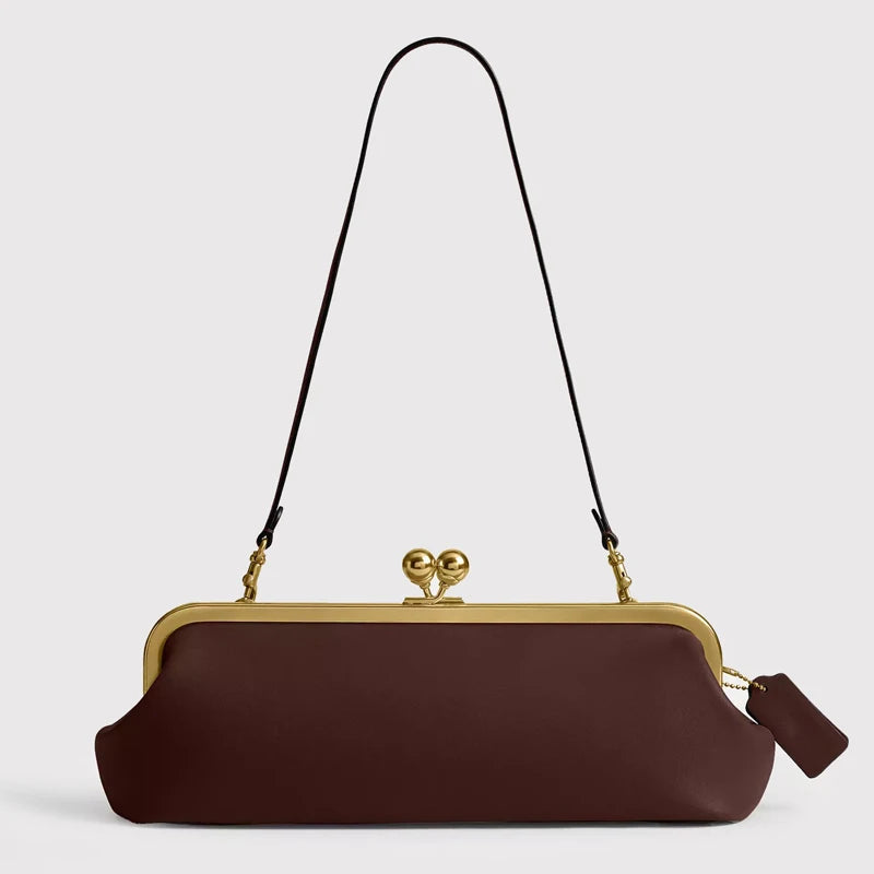 Black classic 30 cm women's handbag with kiss lock closure, featuring a sleek design from Corporación Turística.