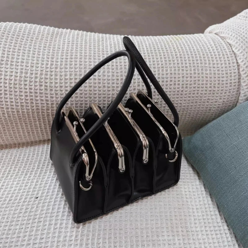 Black multi-layer shell clip handbag for women, featuring a sleek design and compact size, ideal for stylish evening accessories.