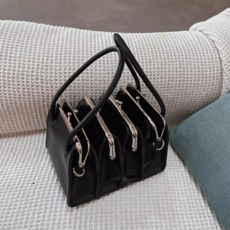 Black multi-layer shell clip clutch bag for women, with a sleek design and compact size, by Corporación Turística.