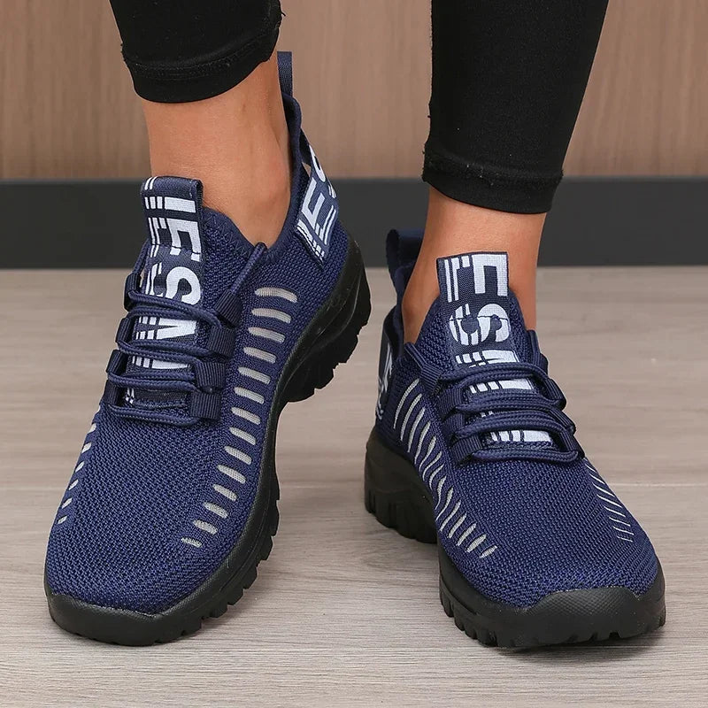 Black men's 2025 fashion mesh running shoes by Corporación Turística, featuring breathable material and sporty design.
