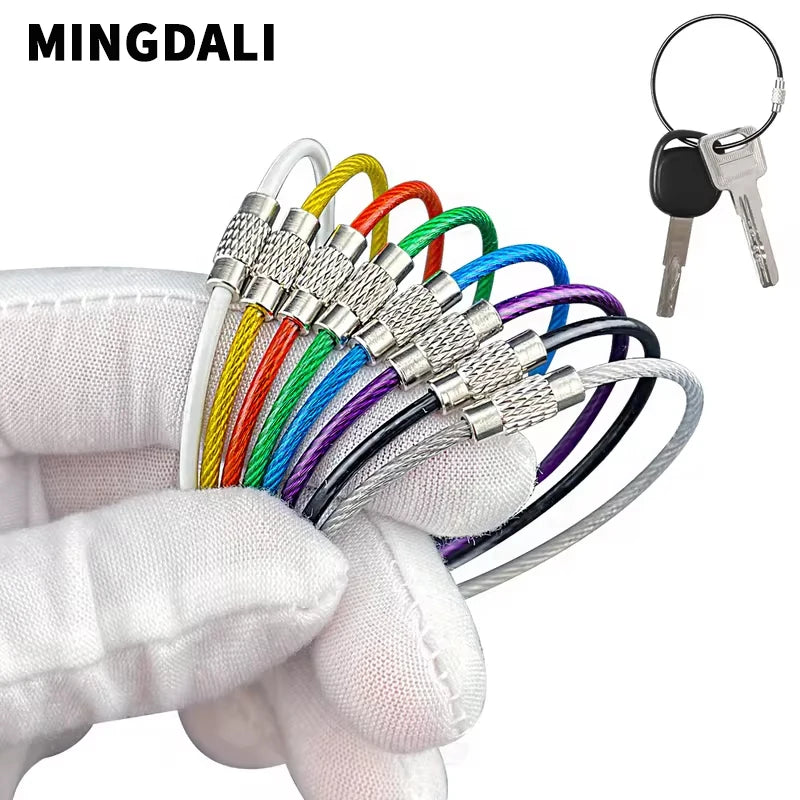 Set of five black stainless steel wire keychains coated with PVC, durable and lightweight key accessories from Corporación Turística.