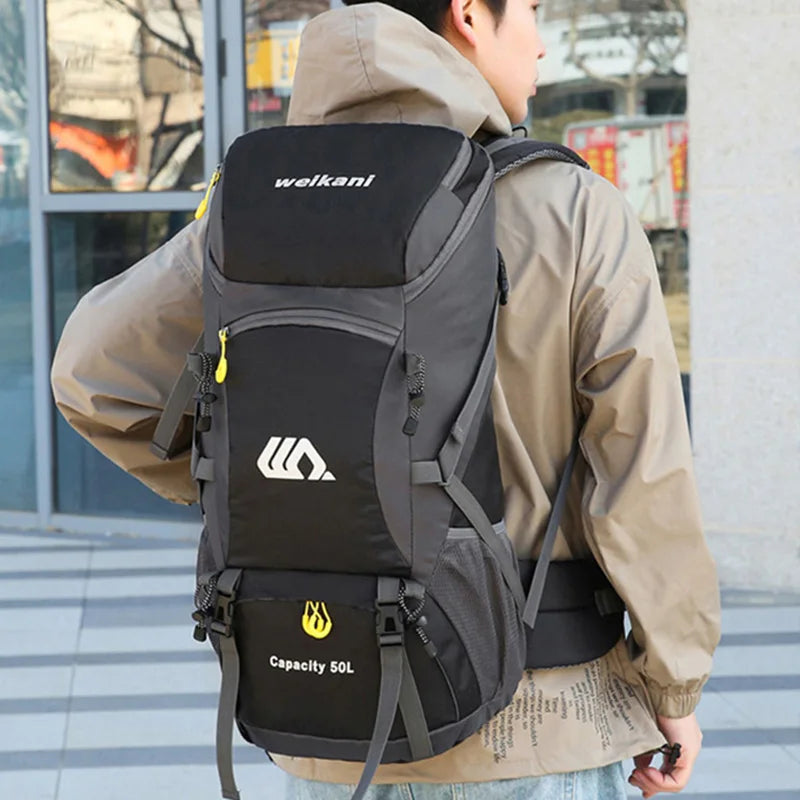 Large 50L camping travel backpack with black cover from Corporación Turística, suitable for outdoor adventures and camping trips.