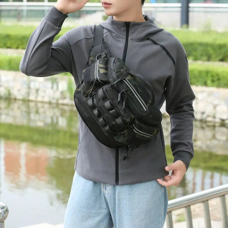 Black tactical fishing waist bag with compartments, designed for lure fishing and travel, by Corporación Turística.