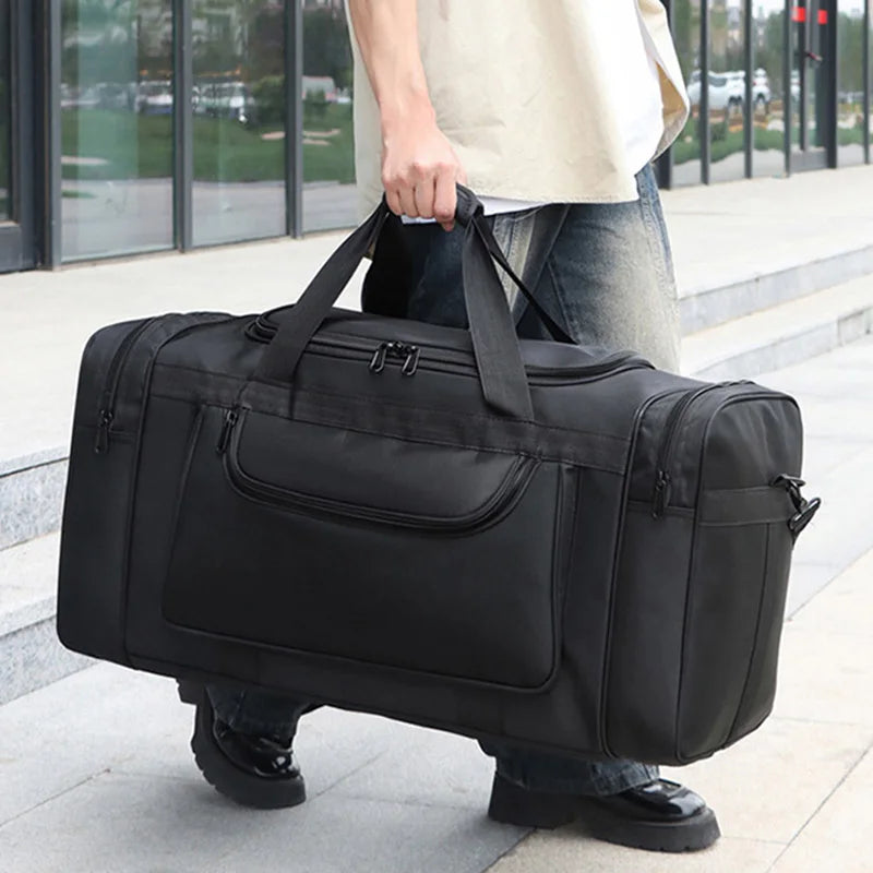 Large travel bag by Corporación Turística for men and women, sports-style black duffel bag with multiple compartments.