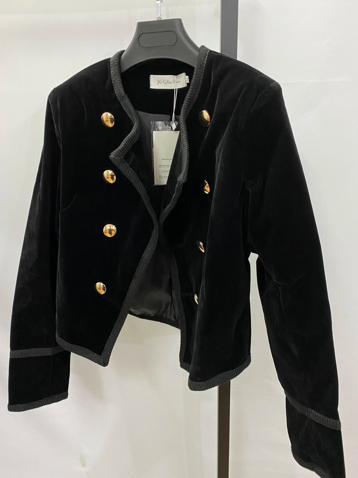 Black women's short jacket by Corporación Turística, stylish autumn-winter coat with a modern fit and cozy fabric.