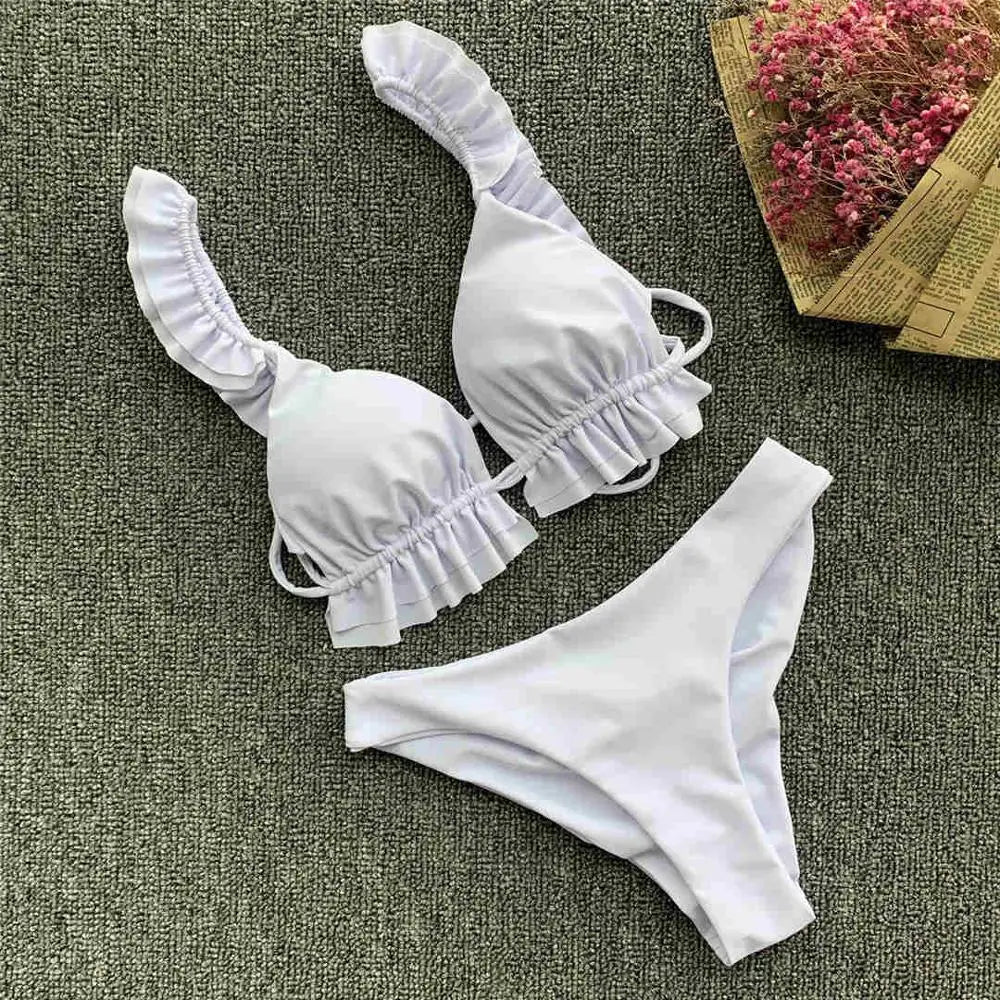 Black women's bikini swimsuit with ruffle details from Corporación Turística, featuring a stylish and modern design for 2026.