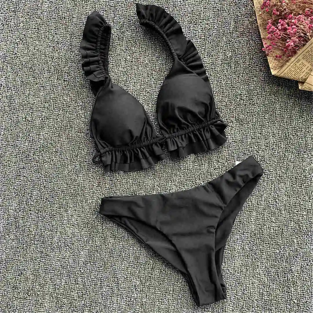 Black women's bikini swimsuit with ruffle details, stylish two-piece bathing suit for 2026 from Corporación Turística.