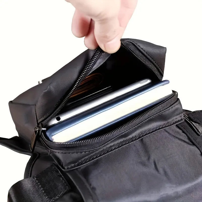 Black men's utility waist bag with leg strap, designed by Corporación Turística, for hands-free carrying and convenience.