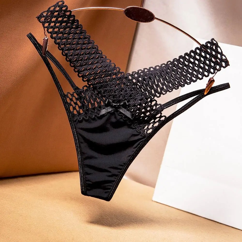 Black and white low-rise tanga underwear with openings, comfortable style by Corporación Turística, shown on a mannequin.