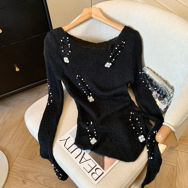 Black women's hollow-knit sweater with bead hole design, stylish and cozy from Corporación Turística.
