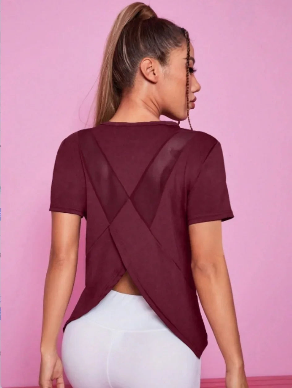 Black women's yoga outfit featuring a summer sports t-shirt from Corporación Turística, suitable for active yoga sessions.