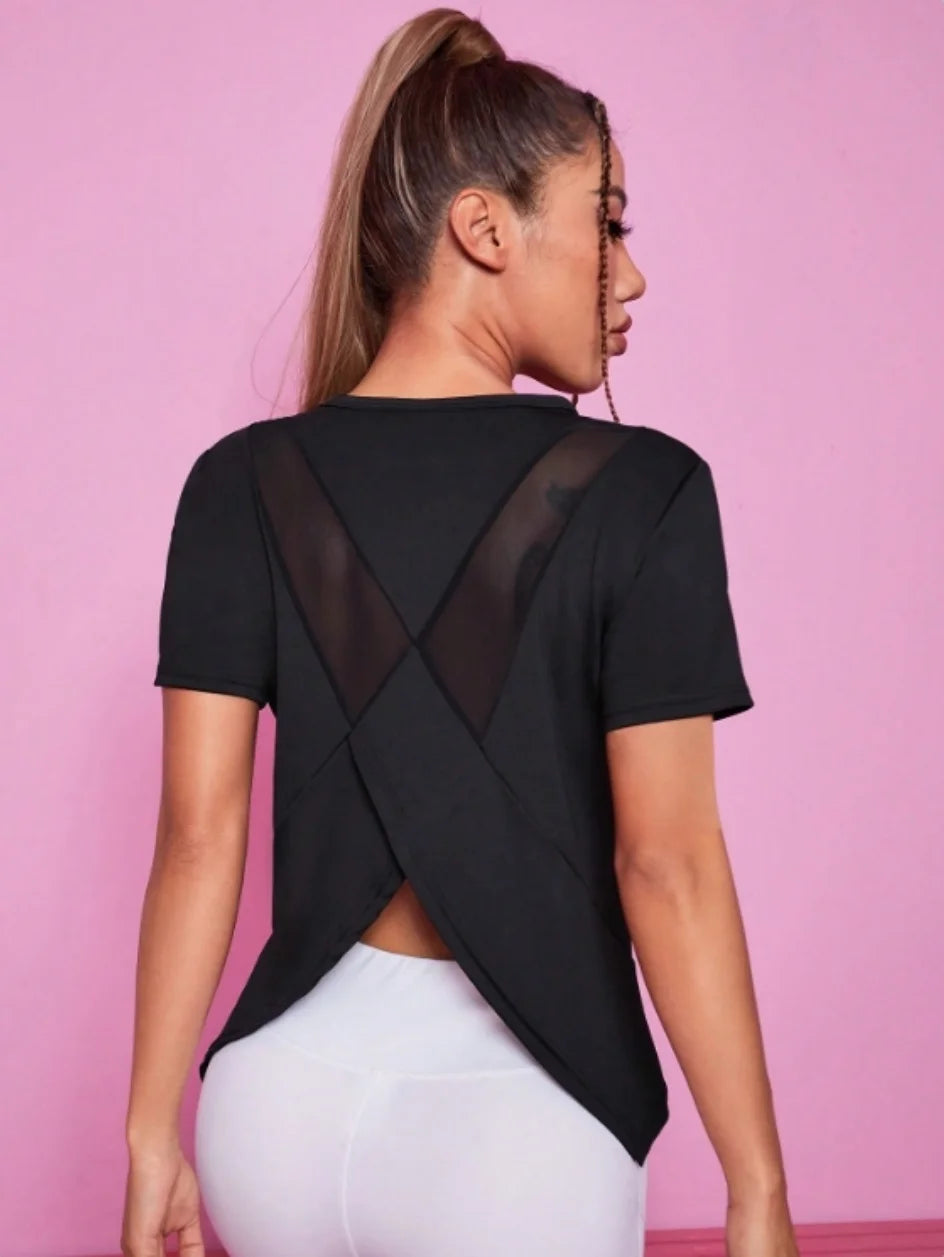 Black women's yoga outfit featuring a summer sports t-shirt from Corporación Turística, suitable for active wear and exercise.