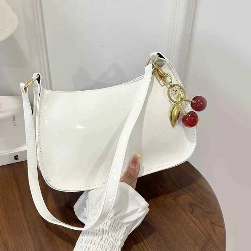 White synthetic leather women's handbag by Corporación Turística, stylish shoulder bag with sleek design and top handle.