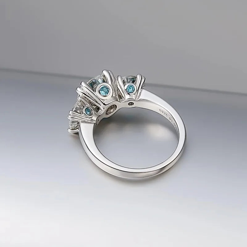 S925 silver ring with moissanite gemstones, plated in platinum, featuring intricate design and sparkling stone accents.