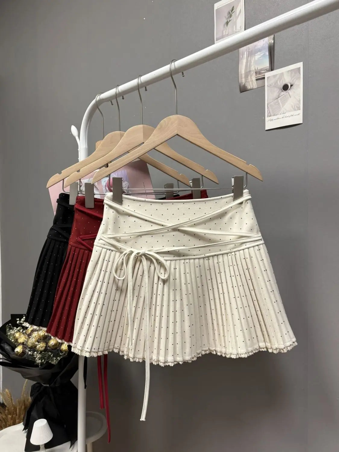 White pleated skirt with crisscross polka dot straps, stylish fashion from Corporación Turística, perfect for trendy outfits.