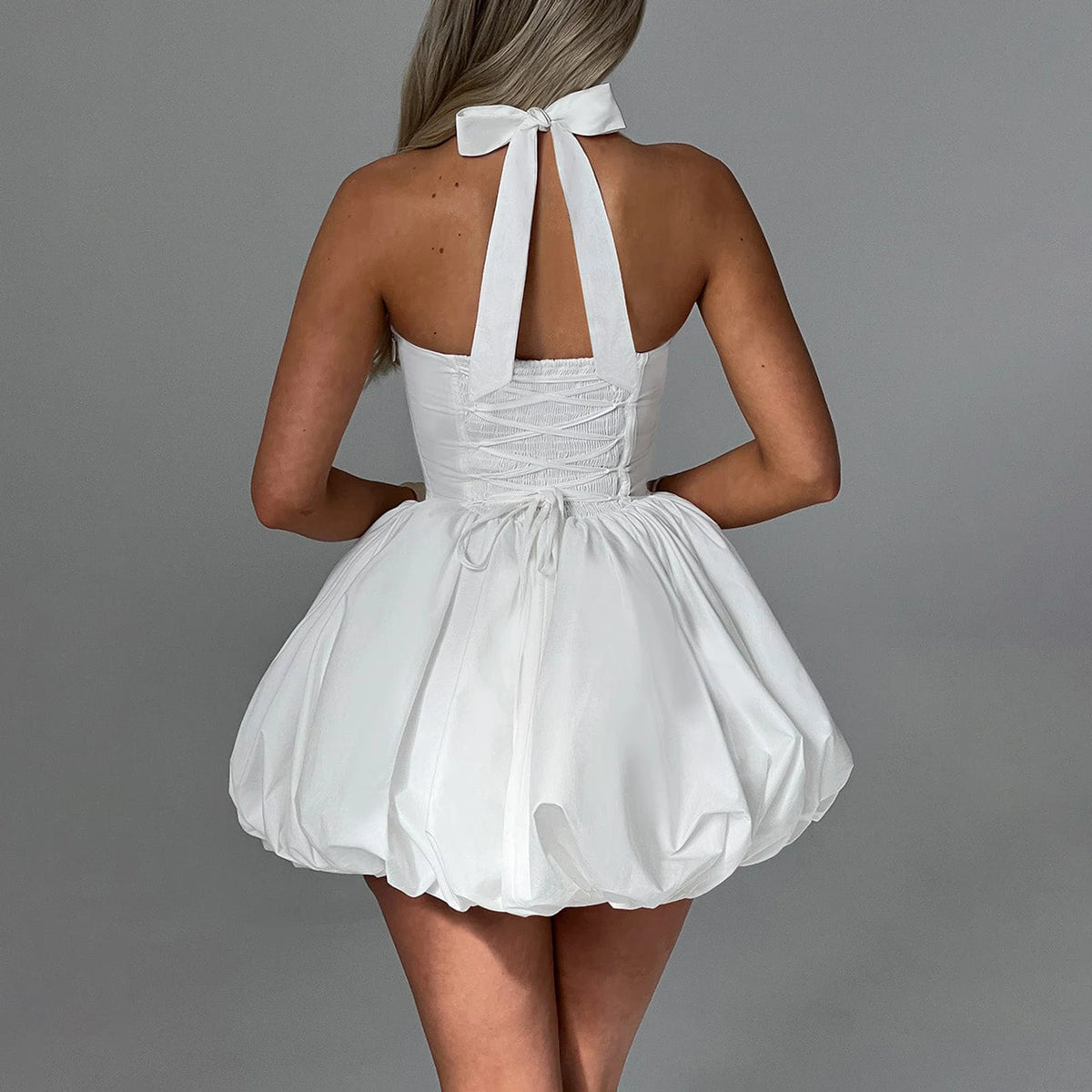 White bubble minivestido halter dress for women, elegant and stylish, by Corporación Turística, shown on a model.